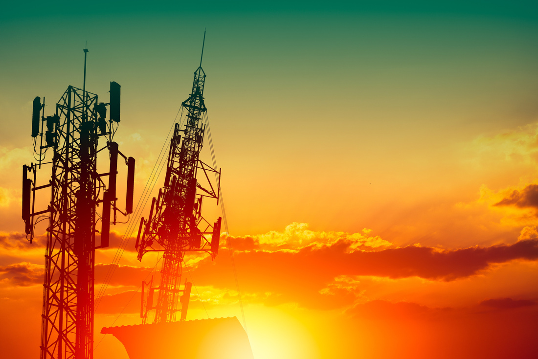 Silhouette of high frequency 5G station communication tower or 4G network telephone cellsite with dusk sunset sky with space for text Silhouette of high frequency 5G station communication tower or 4